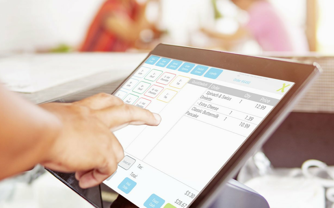 Staff using POS tablet to enter customer order