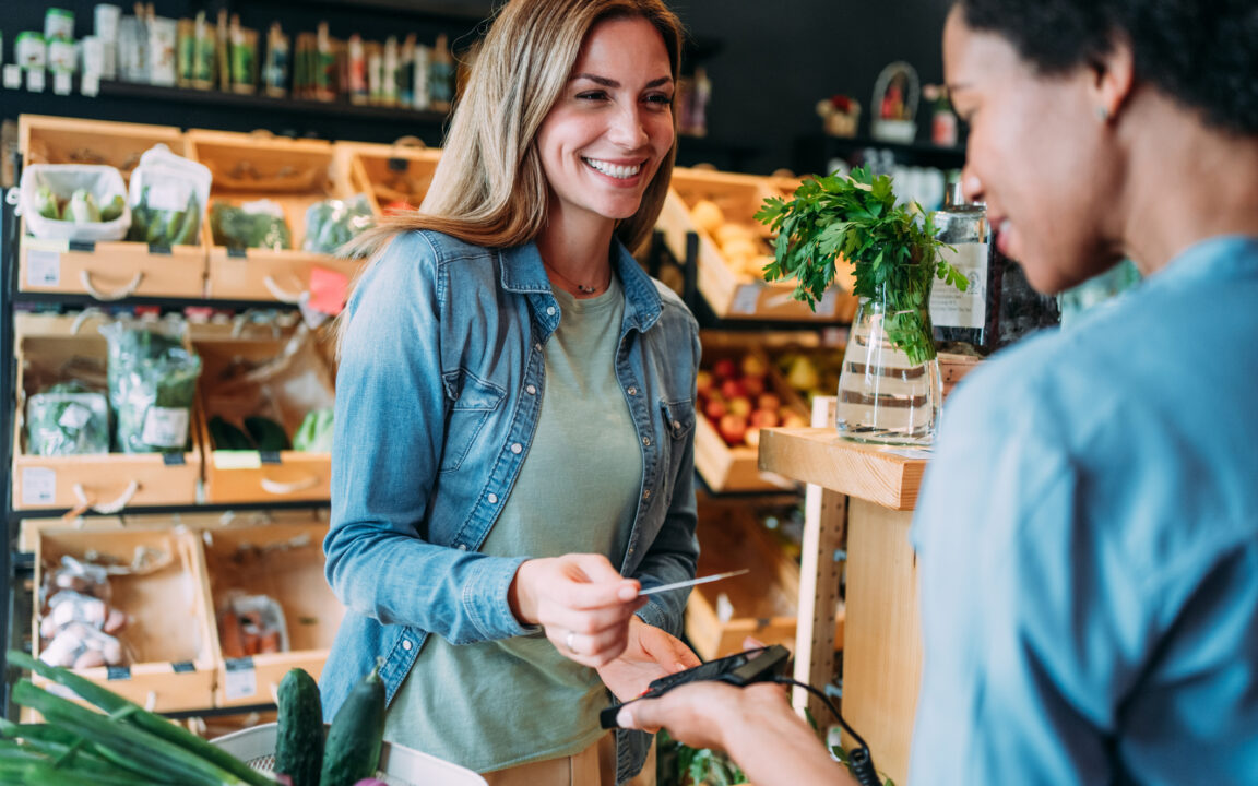 Woman paying for groceries with card